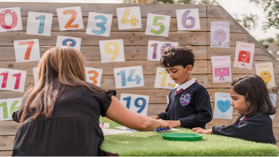 Teacher and pupils speaking at Aragon Primary