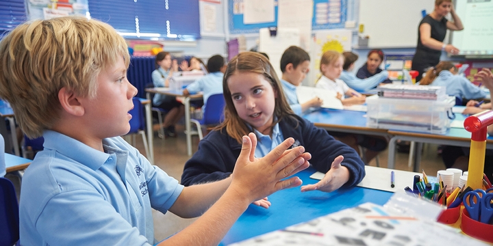 Primary education students discussing a mathematical problem