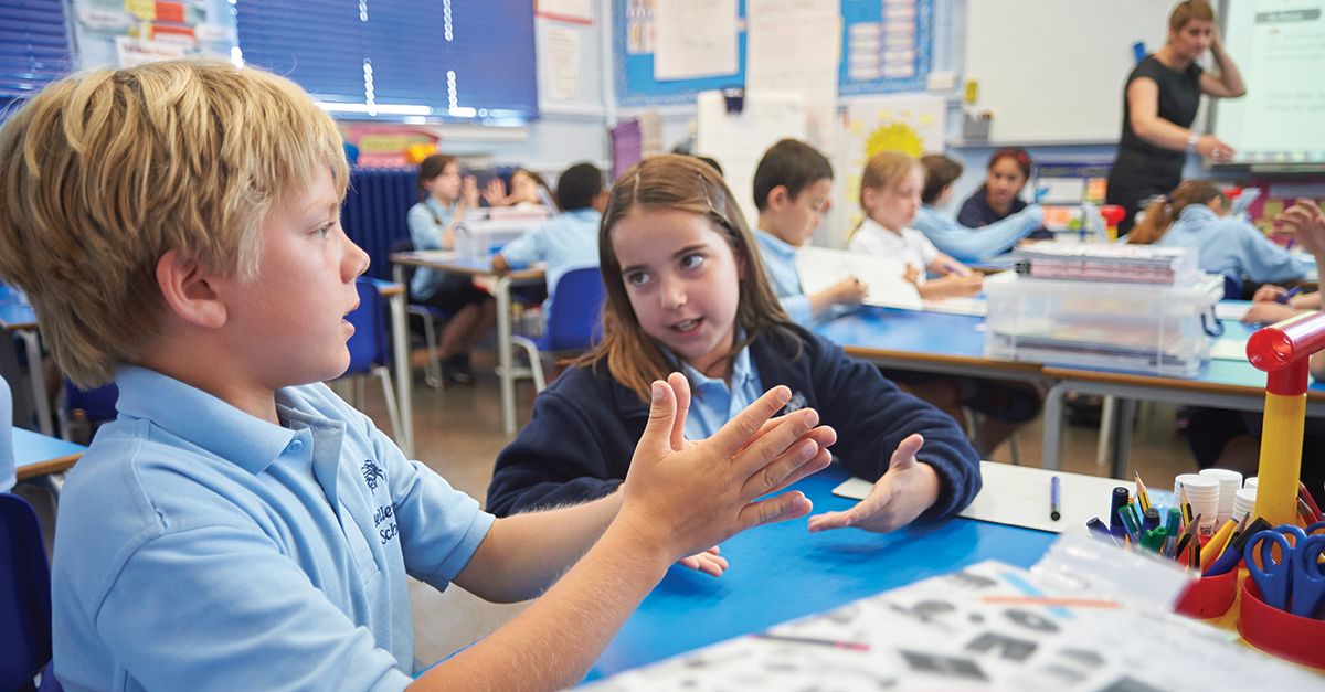 Primary education students discussing a mathematical problem