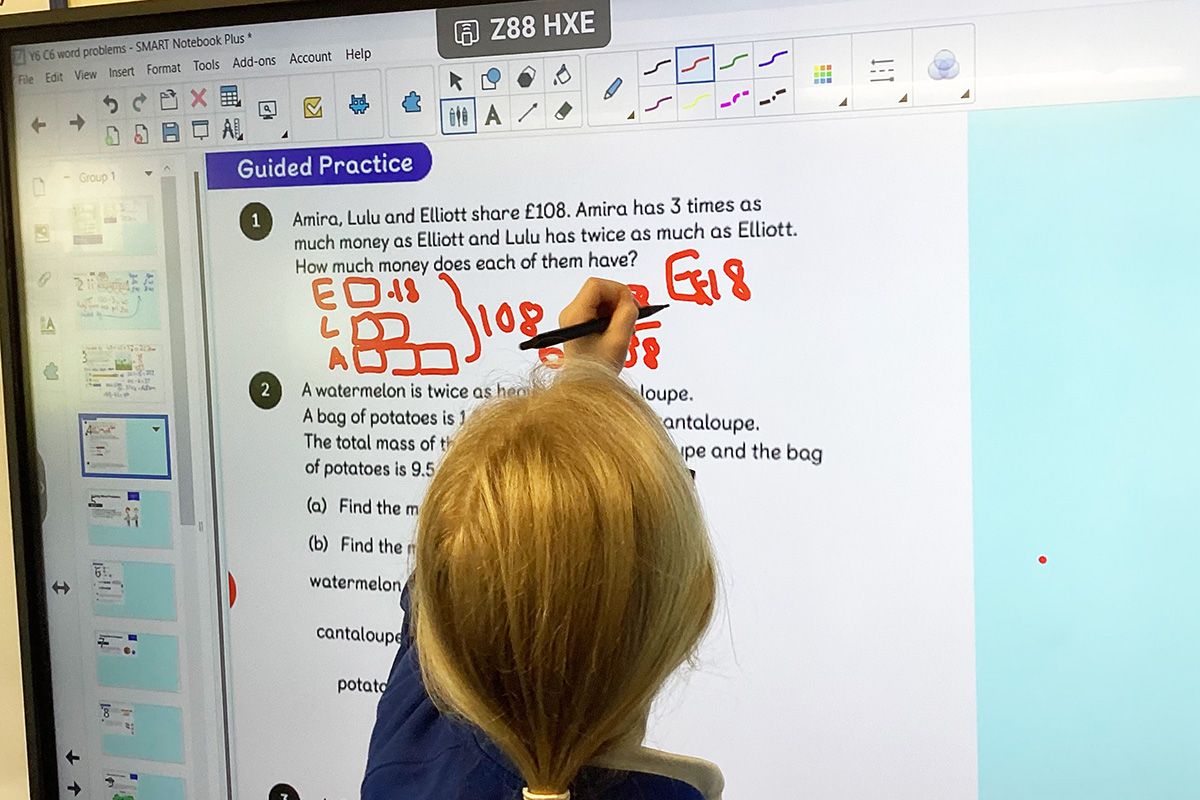 Pupil writing on the board at Stanton St Quintin Primary