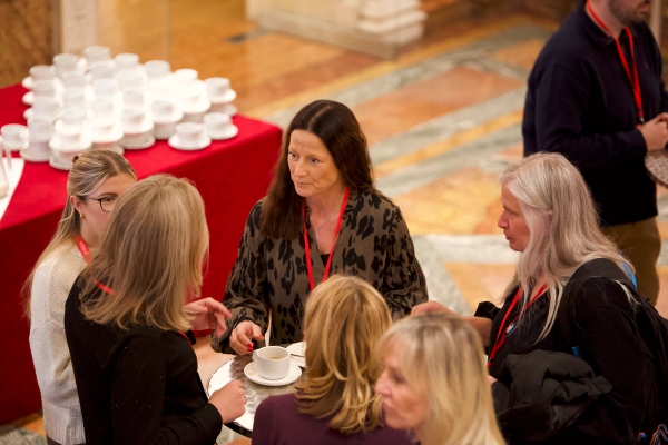 event delegates talking during coffee break