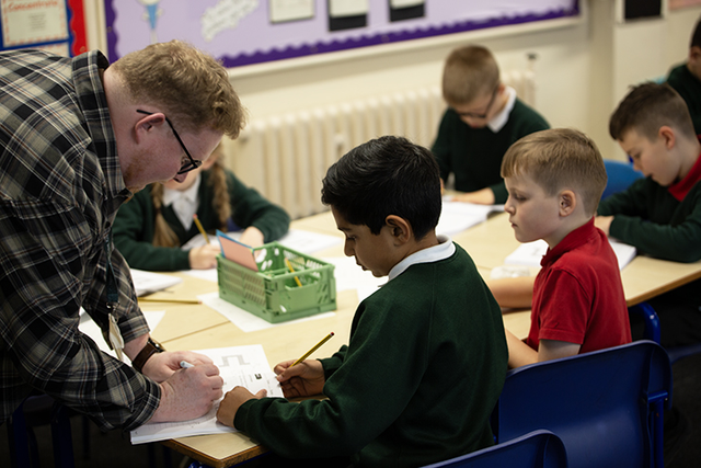Teacher working with pupils.