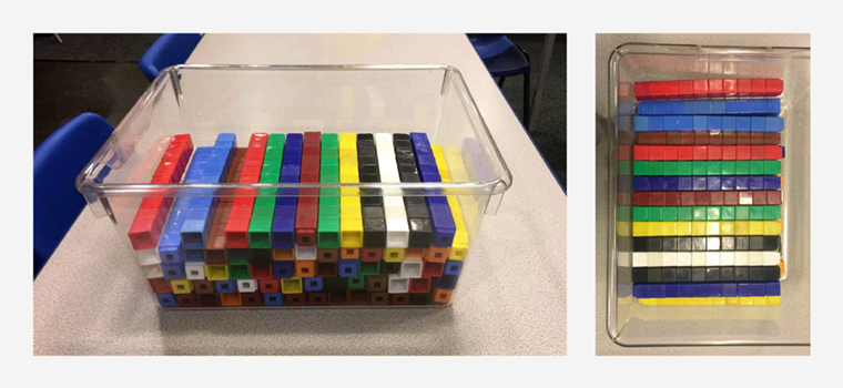 Sticks of Maths teaching manipulatives ten linking cubes are shown neatly organised by colour in a plastic container.
