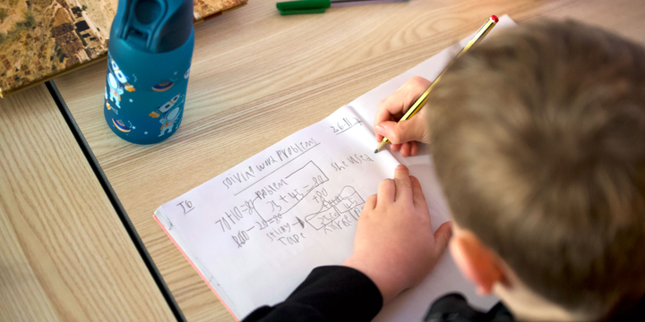 pupil writing in maths journal st marys blog