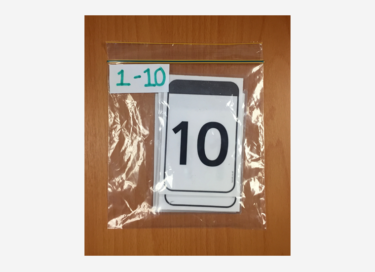 A set of Maths digit cards are shown labeled and organised in a snap lock bag.
