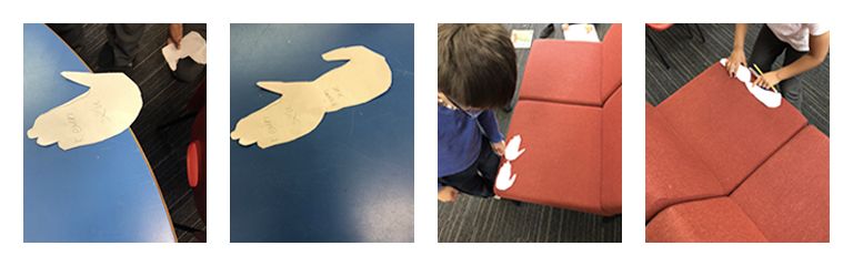 Students using cut outs of hand and feet to measure