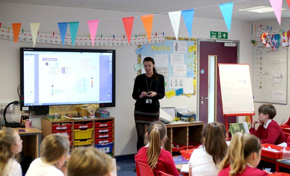 Teacher in classroom speaking to class