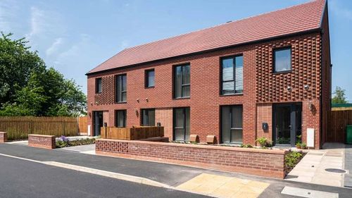 Terrace of Passivhaus homes with red bricks