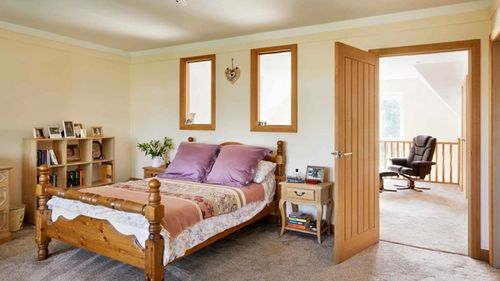 Bedroom with oak door and vintage furniture
