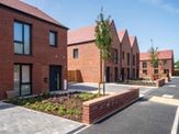 Passivhaus homes all built in red bricks with anthracite windows
