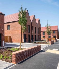 Passivhaus homes all built in red bricks with anthracite windows