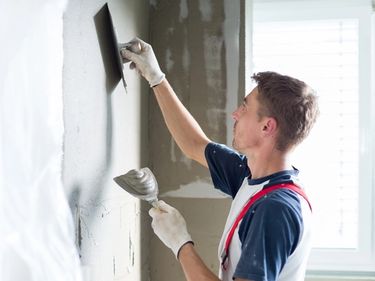 man plastering internal walls