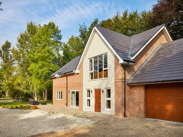 Detached house with garage on a bright day