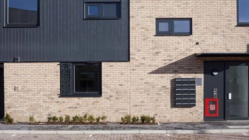 Apartment block with FSC-Certified black timber and brick cladding