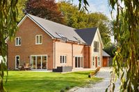 detached timber frame house with bifold doors