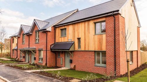 Passivhaus dwellings with red bricks and timber cladding