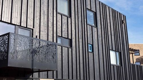 Apartments with black timber cladding