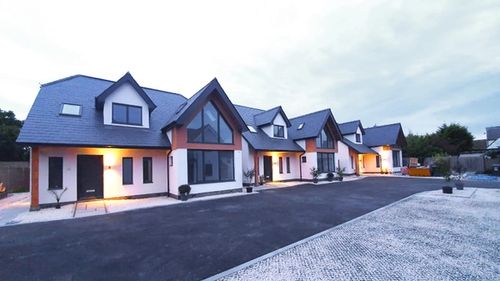 Row of 4 contemporary house designs with large gable windows