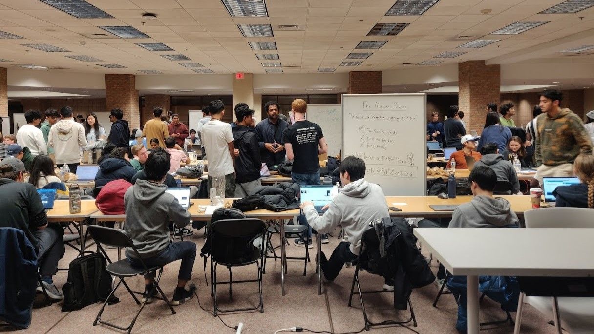 A group of students working on laptops at a hackathon