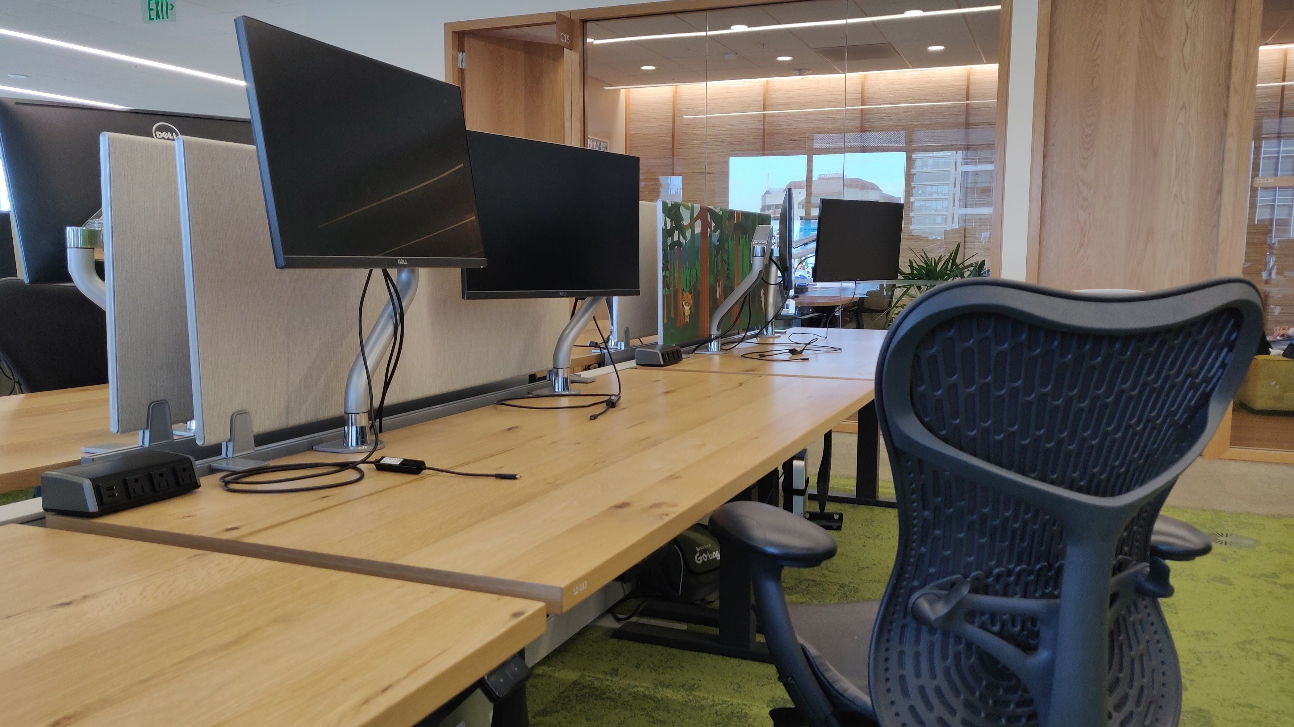 Desk chair and an adjustable desk with two monitors