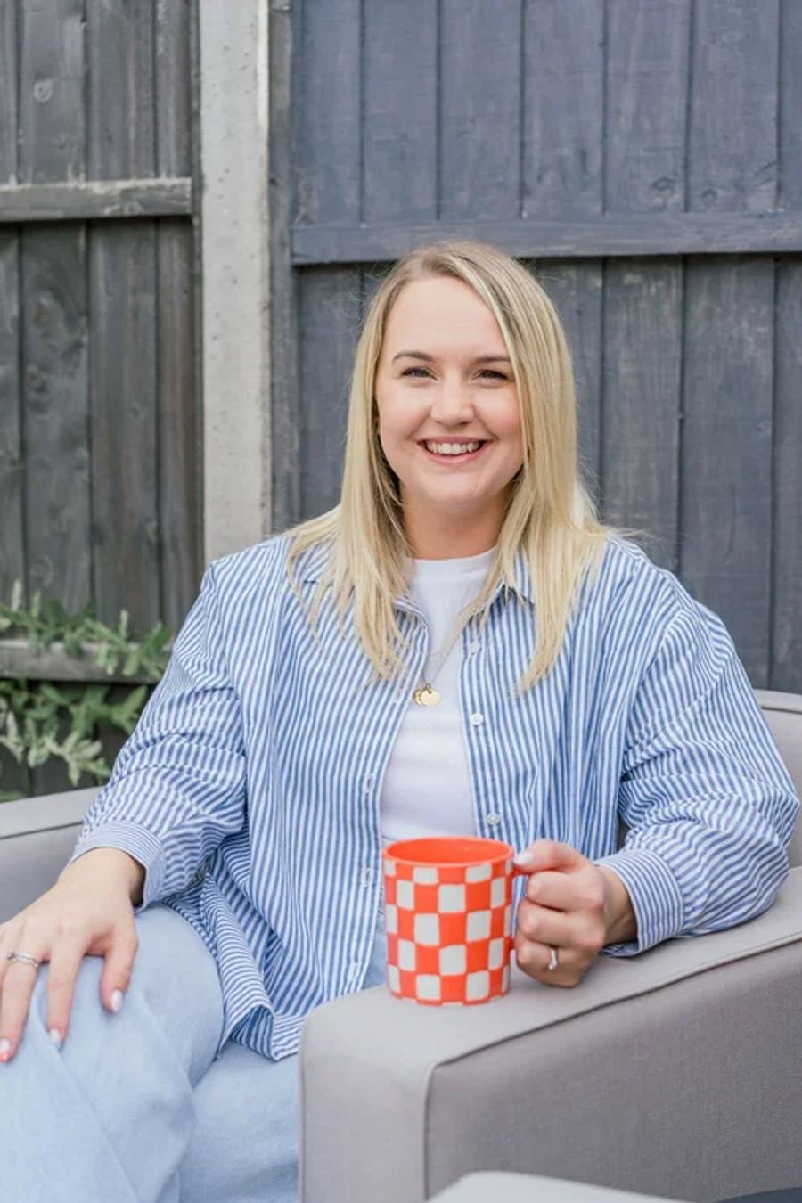 Beth from Budgeting Mum holding a mug
