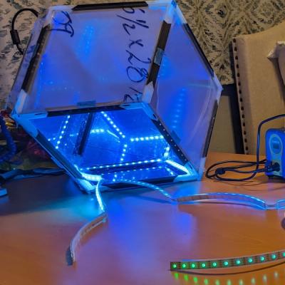 Progress photo of the Rhombotron with LED segments soldered together and partially installed in the frame