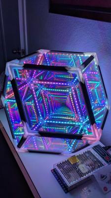 Glowing 3-dimensional LED sculpture with power supply on a credenza