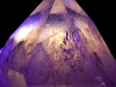 Fissures and air bubbles reveal themselves in the quartz crystal through the refraction of the LEDs