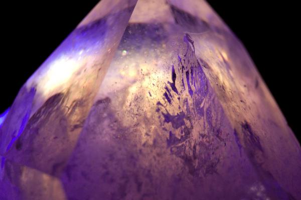 Fissures and air bubbles reveal themselves in the quartz crystal through the refraction of the LEDs