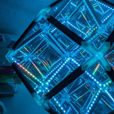 Photo of the Rhombotron glowing blue with hints of a rain