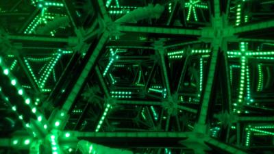 View into bright green LED artwork, with white 3D-printed articulated lizard inside