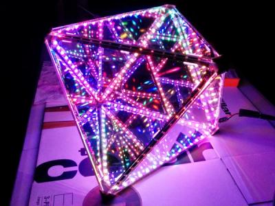 An octahedron with half mirrored faces, reflecting and transmitting the multicolored LEDs installed internally along the edges
