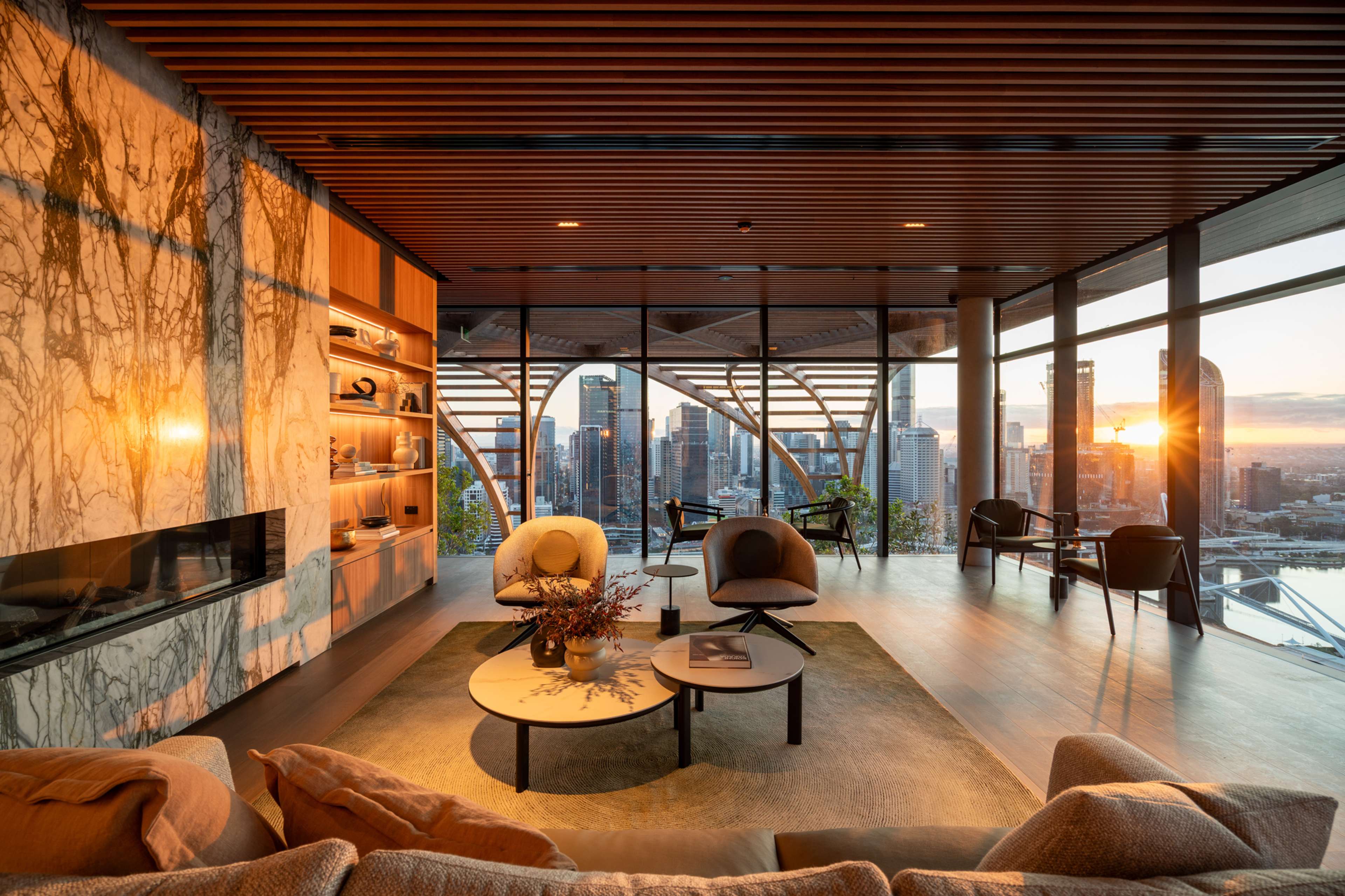 Upper Club lounge with fireplace and city views at Upper House by Aria