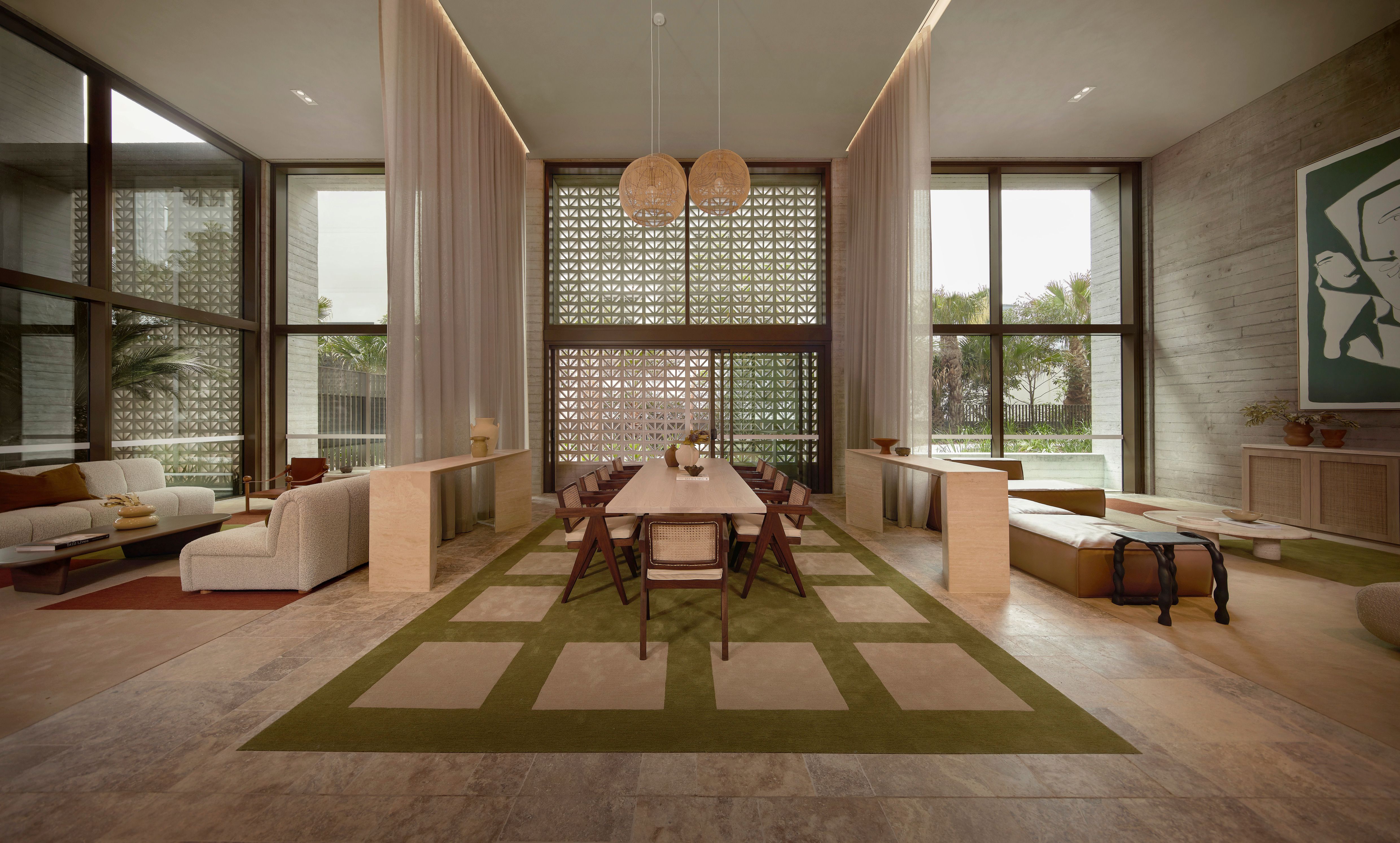 Double-height residents' lounge and dining space at Rivière by Aria
