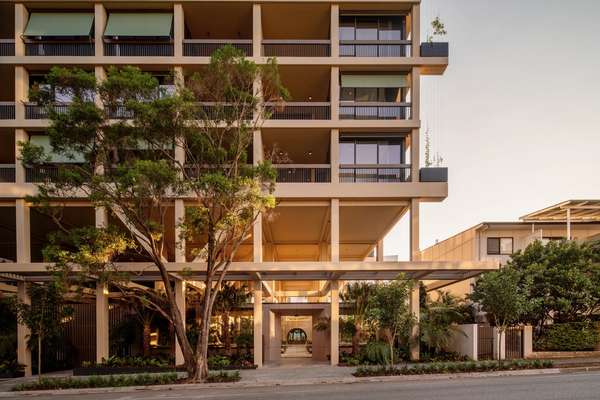 Trellis by Aria in Brisbane, Queenslander inspired façade including lush greenery and sunset skies.