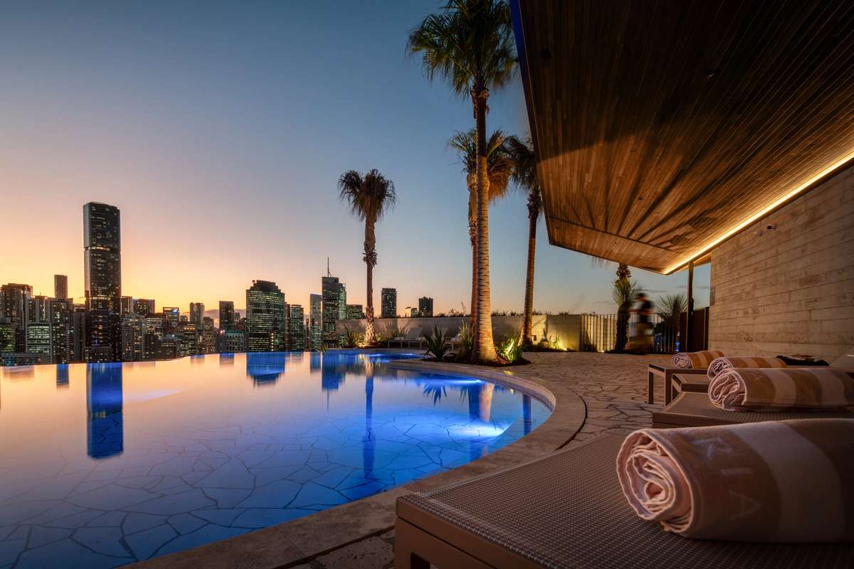 Riviere by Aria, luxury apartment development rooftop pool overlooking Brisbane city and river.