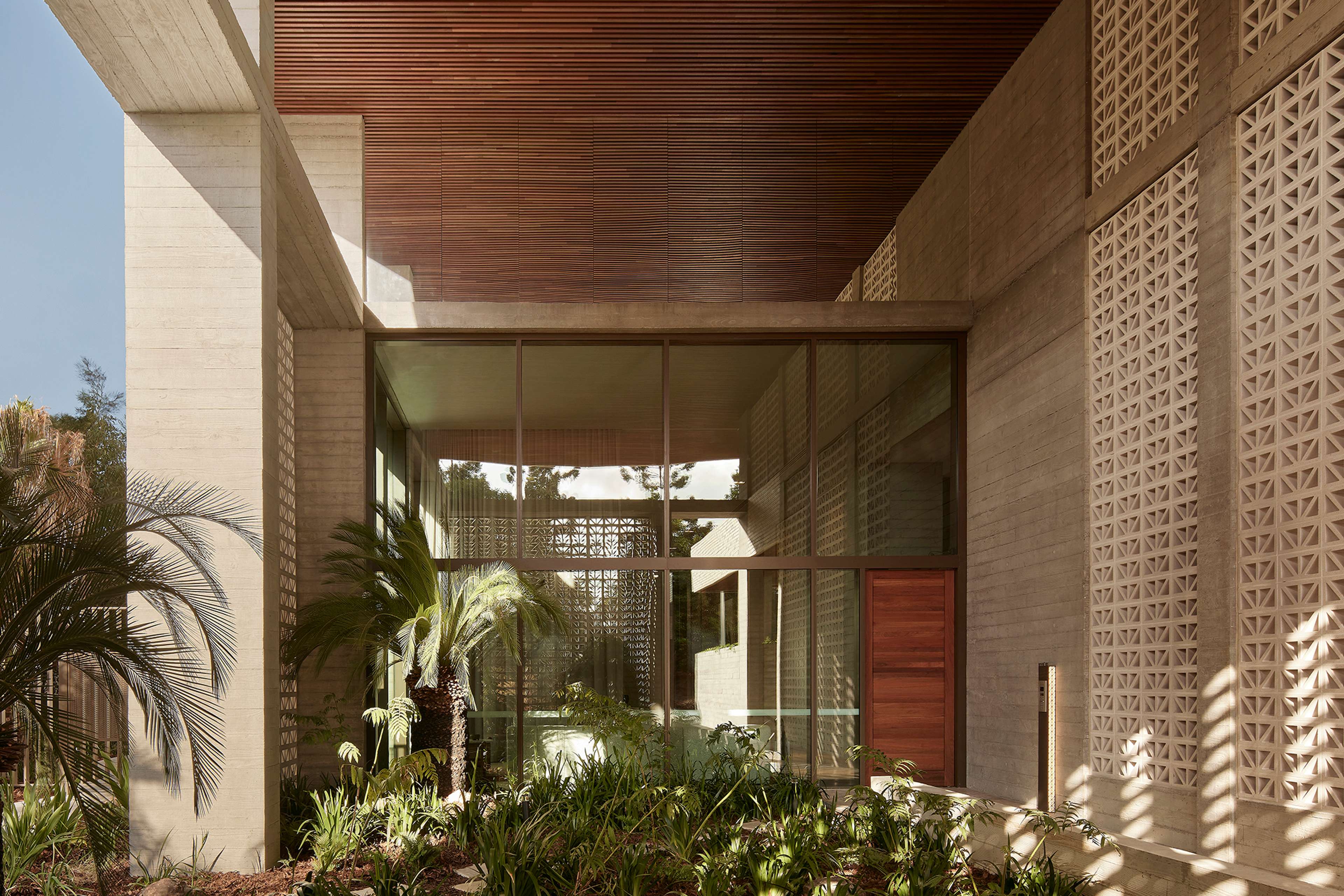 Covered garden walk beneath timber ceilings in The Retreat at Rivière by Aria