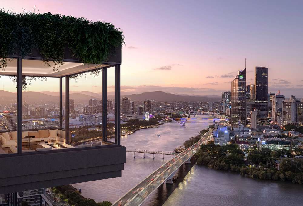 Residents lounge at Cliff by Aria in Brisbane with corner windows, lush greenery, and uninterrupted views over the Brisbane River and city skyline at dusk.