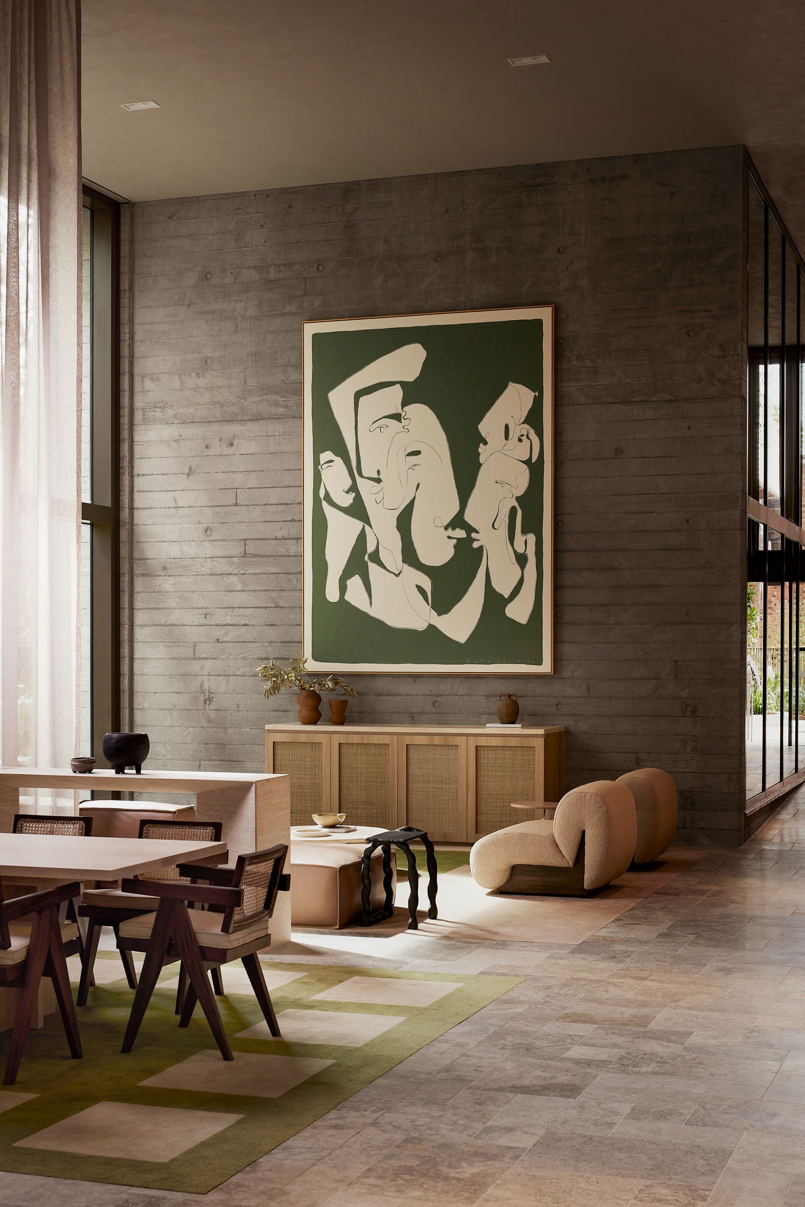 Residents' lounge with artwork and dining setting at Rivière by Aria