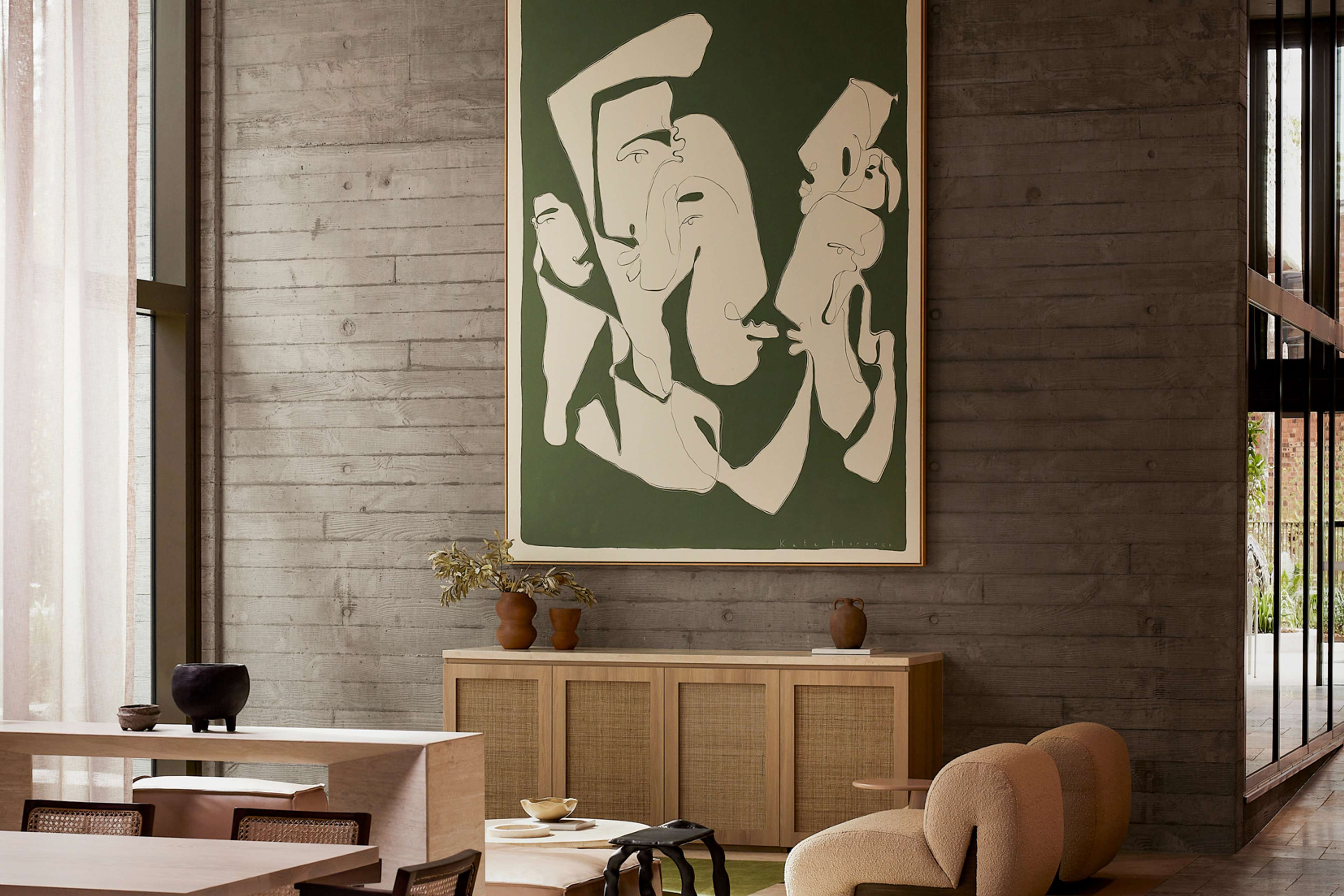Residents' lounge with artwork and dining setting at Rivière by Aria