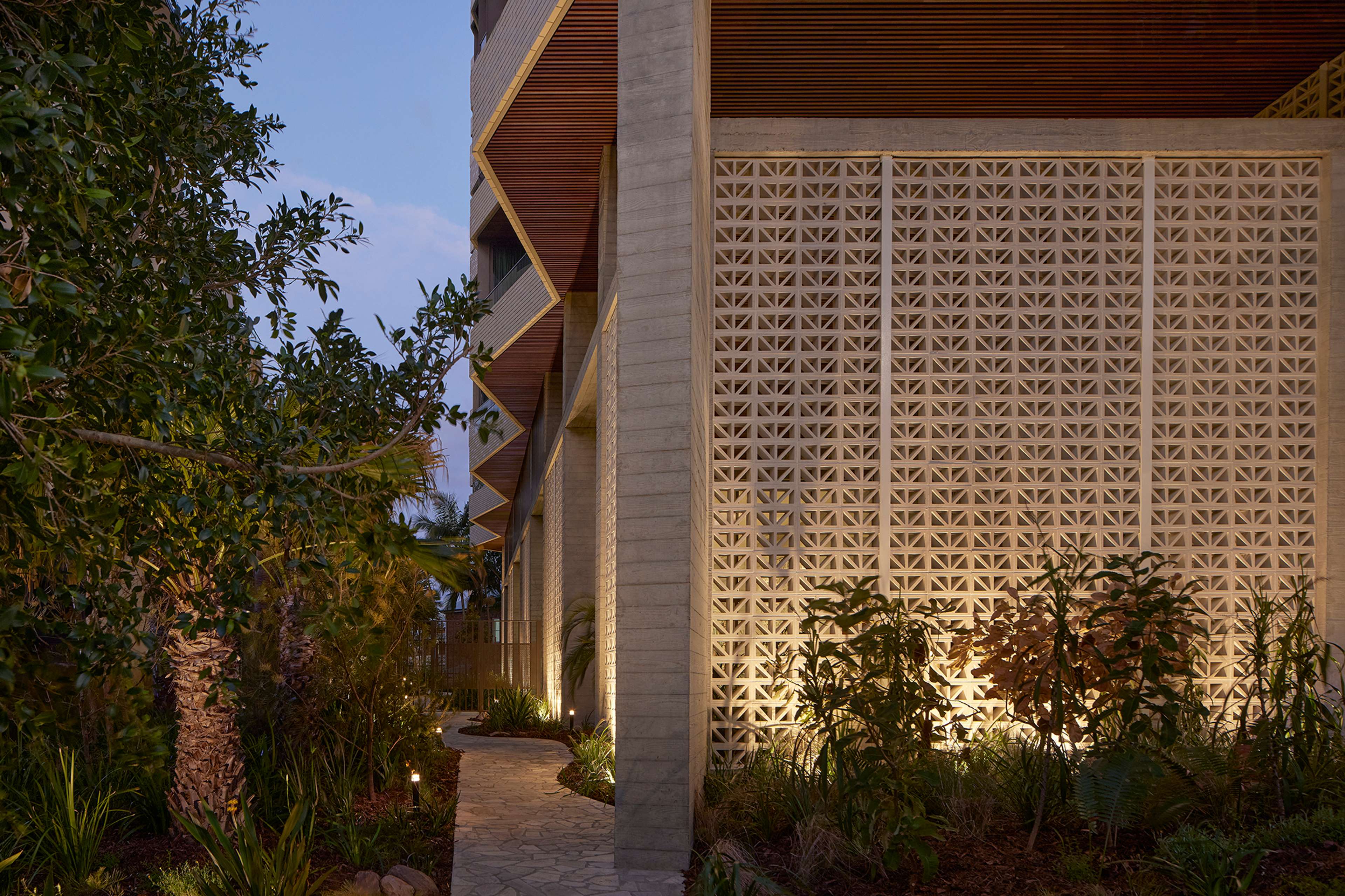 Garden path beside the patterned breeze block screen at Rivière by Aria