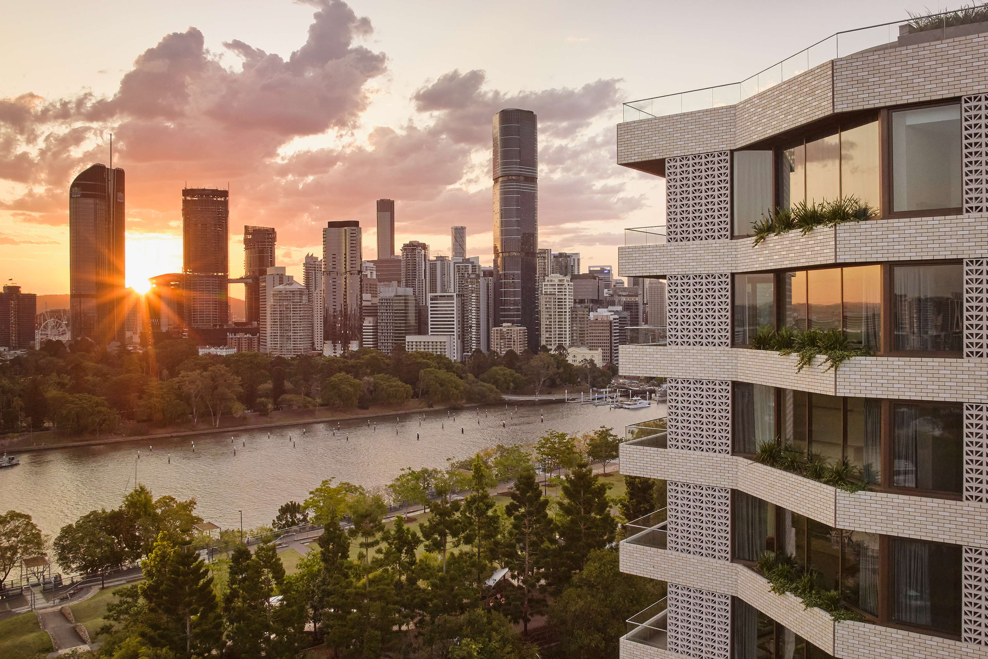 Rivière by Aria at sunset, looking across the river to the Brisbane city skyline