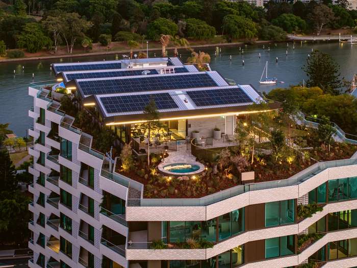 Rooftop garden and spa at Riviere by Aria in Brisbane, featuring solar panels, landscaped terraces, and views over the Brisbane River.