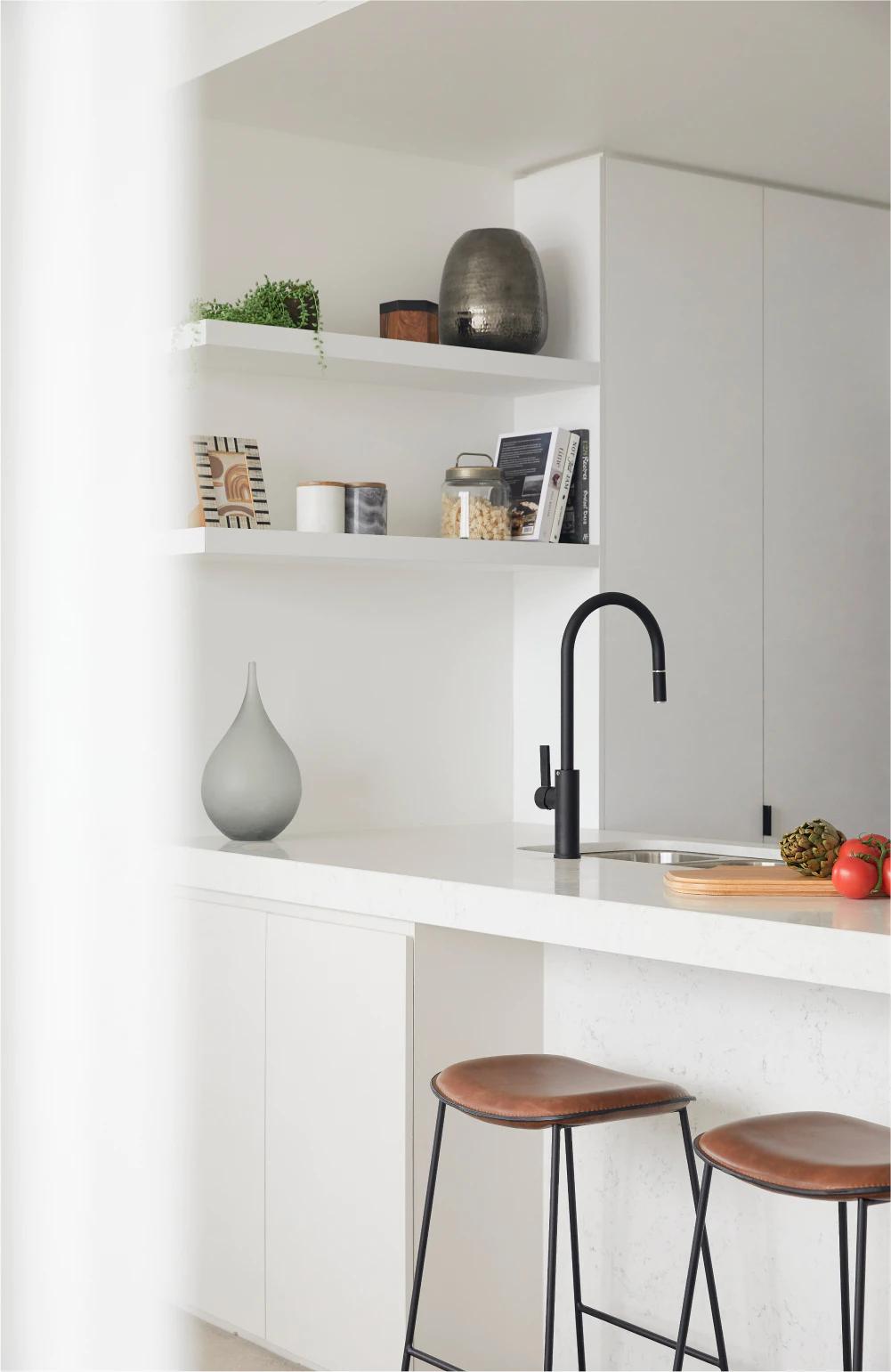 The Drapery by Aria, white and light modern kitchen finishes.