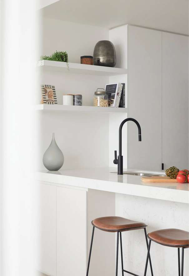 The Drapery by Aria, white and light modern kitchen finishes.