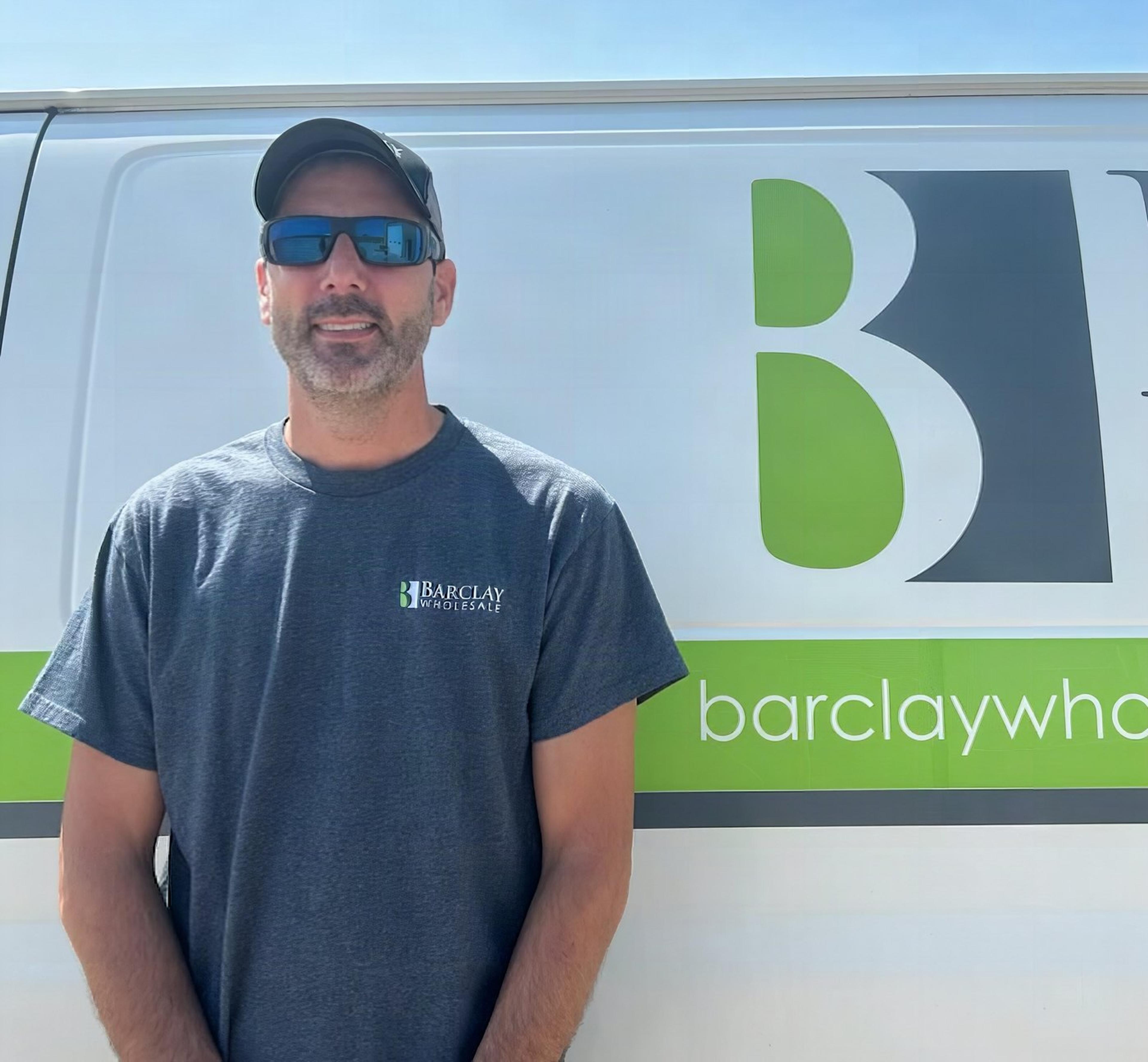 Barclay Wholesale's service technician in front of the service van