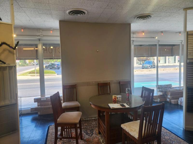Manual solar roller shades on large storefront windows in casual dining seating area