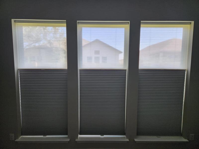Three windows with dual-shade cellular honeycomb blinds, sheer top and dark bottom panels