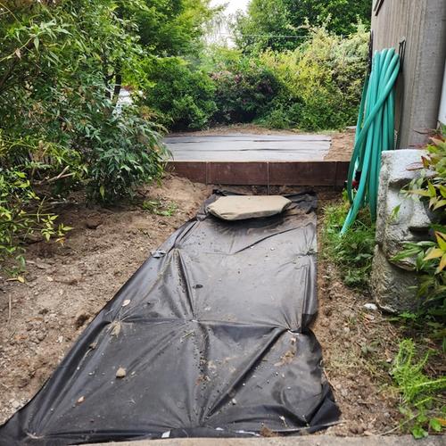 Creatively placed landscaping stone to provide access to the home's water shutoff