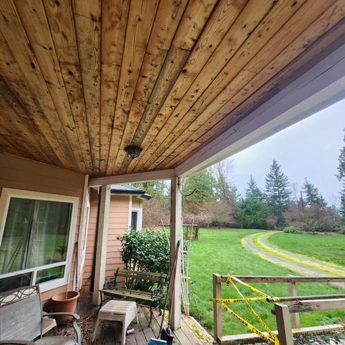 warped and aged ceiling panels on front porch